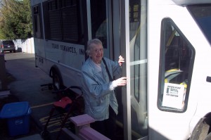 Phyllis Paul climbing aboard the Team Bus for an afternoon of shopping